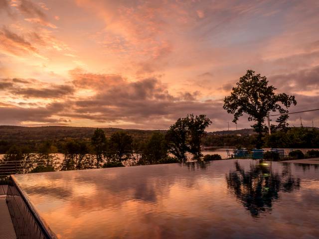 Abenddämmerung mit Blick vom Pool auf den See