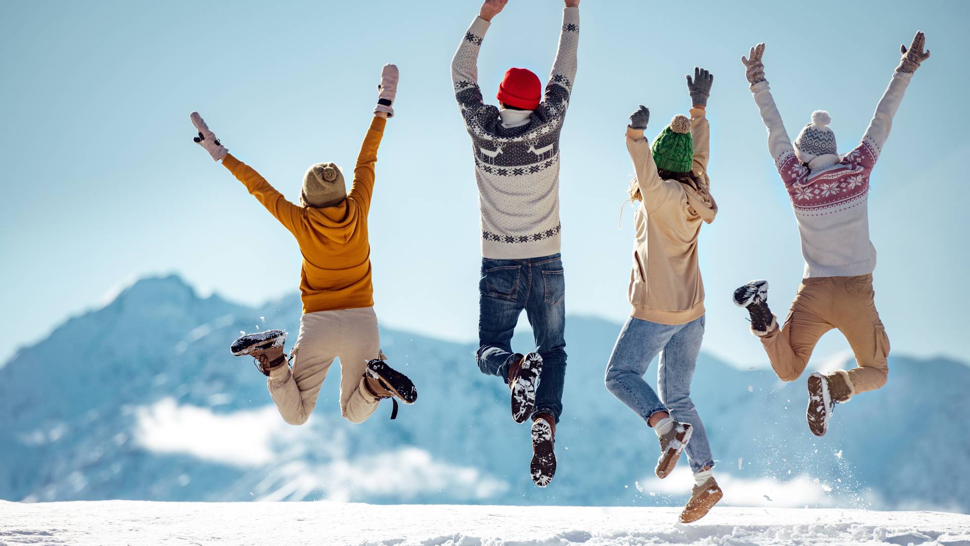 Family jumping for joy in the snow