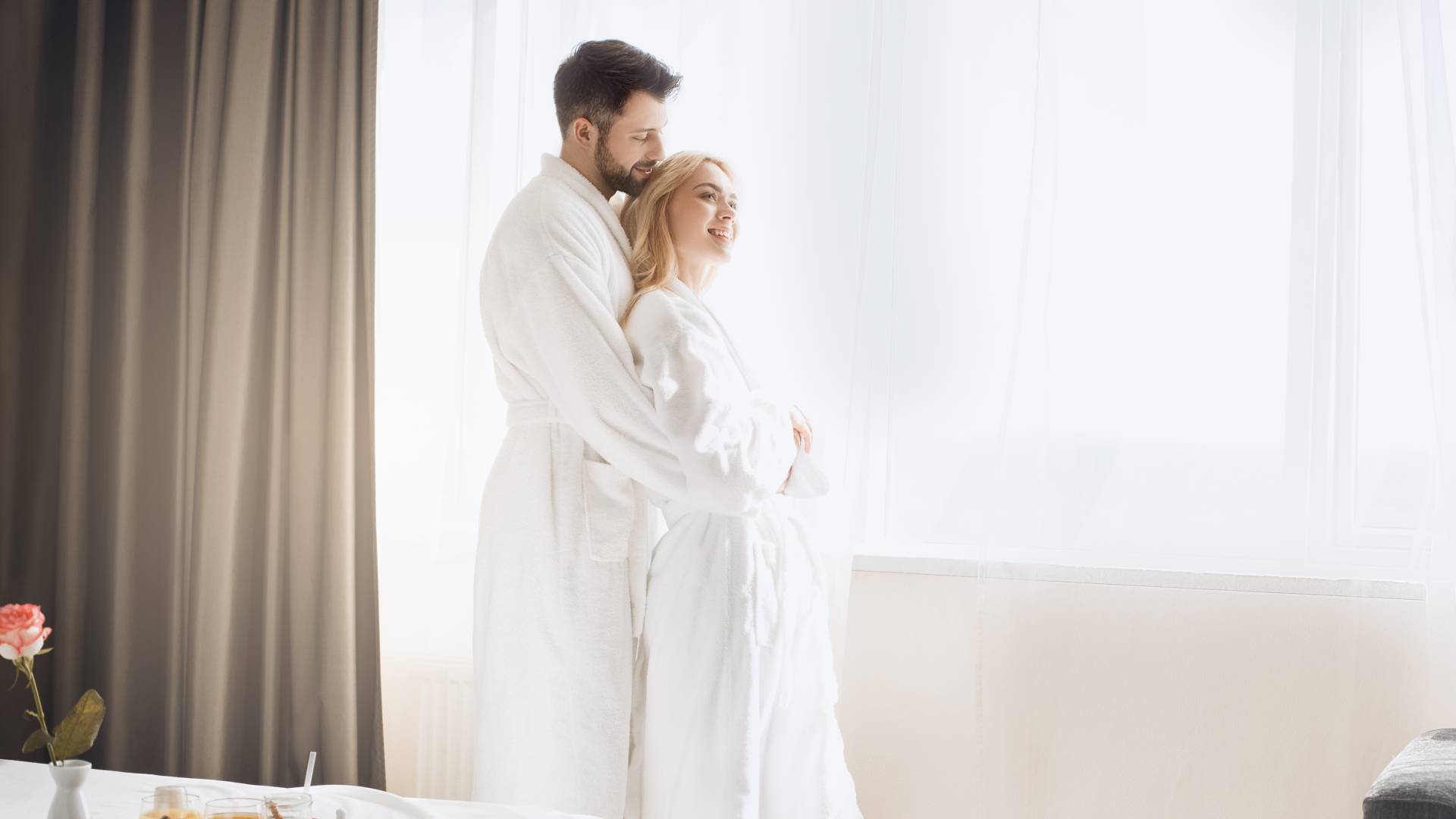 Couple hugging in hotel room