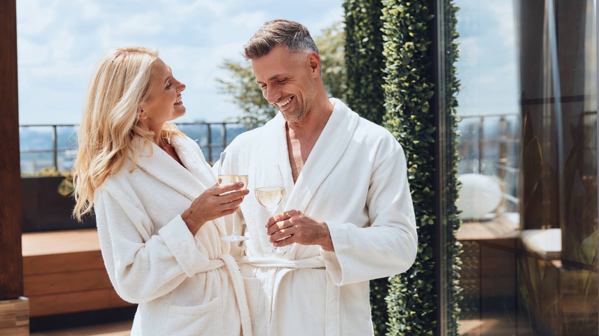 Man and woman toast their vacation with a glass of sparkling wine