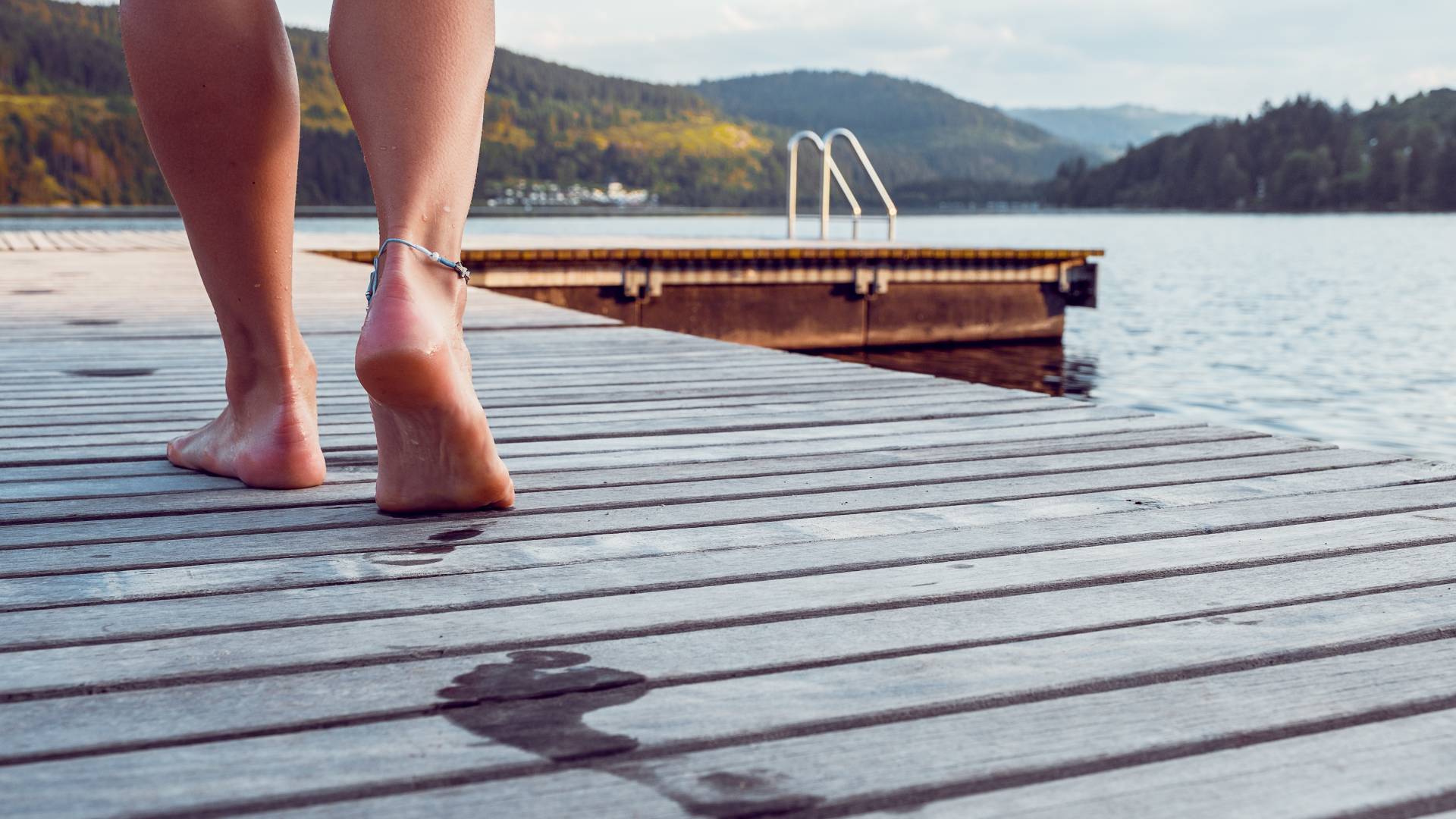 Walking barefoot across a footbridge