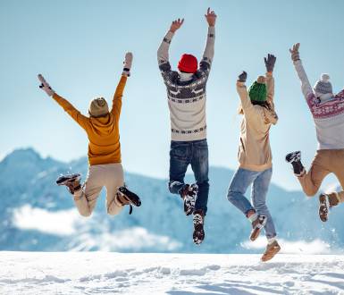 Family jumping for joy in the snow