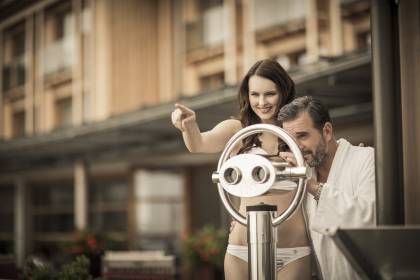 couple looks through a telescope