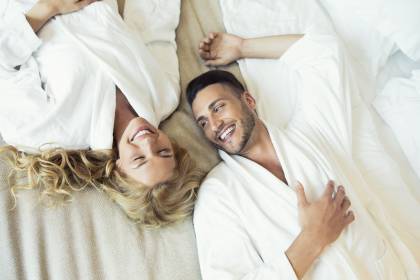Couple lying in bed and laughing
